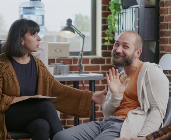 Man having nervous breakdown in front of woman at aa therapy meeting