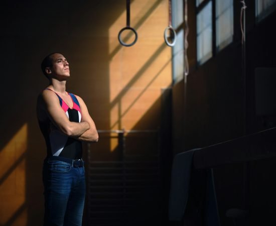 Young male gymnast concentrating before performing his exercises